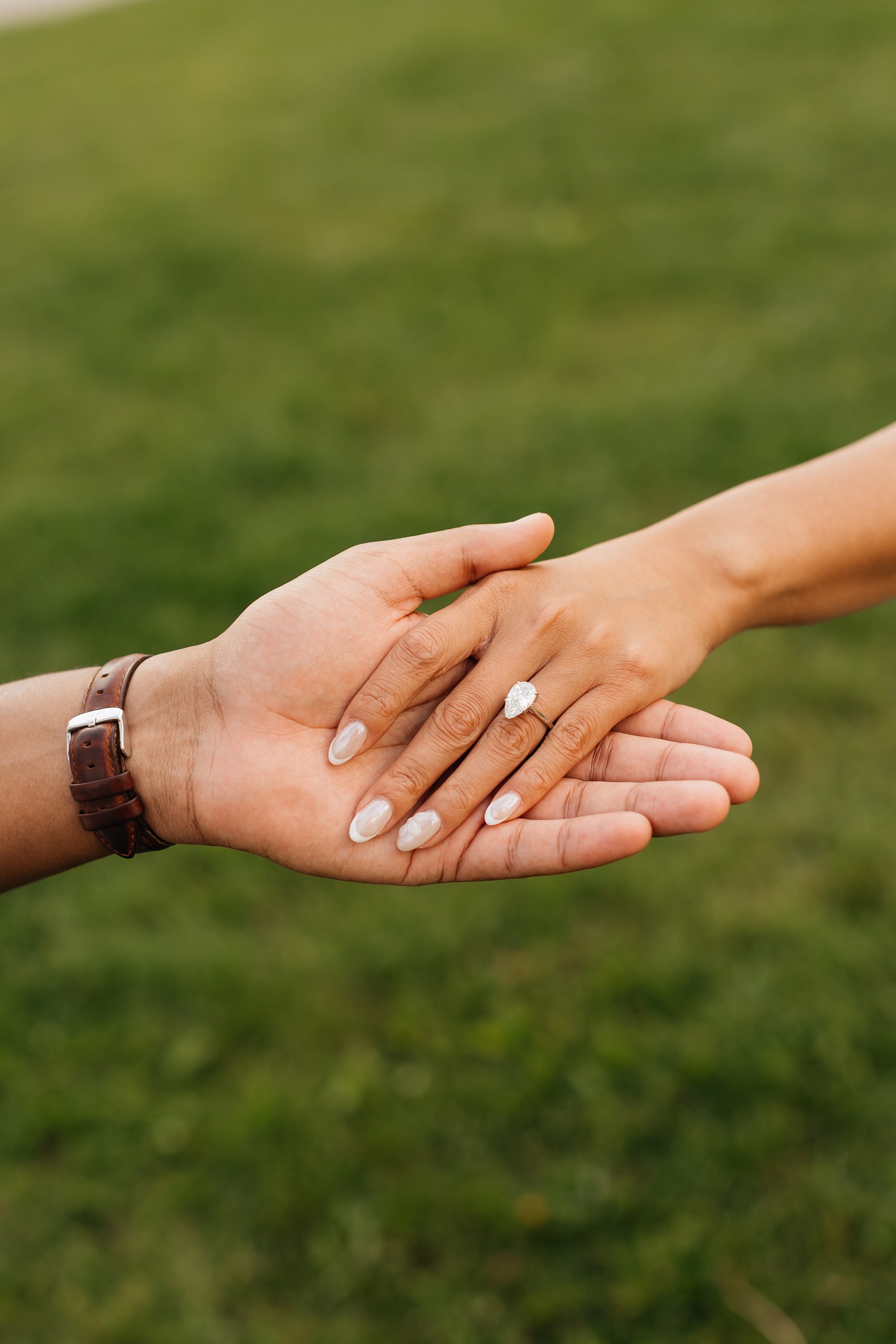 Subhrodeep and Cindy holding hands, showing the engagement ring